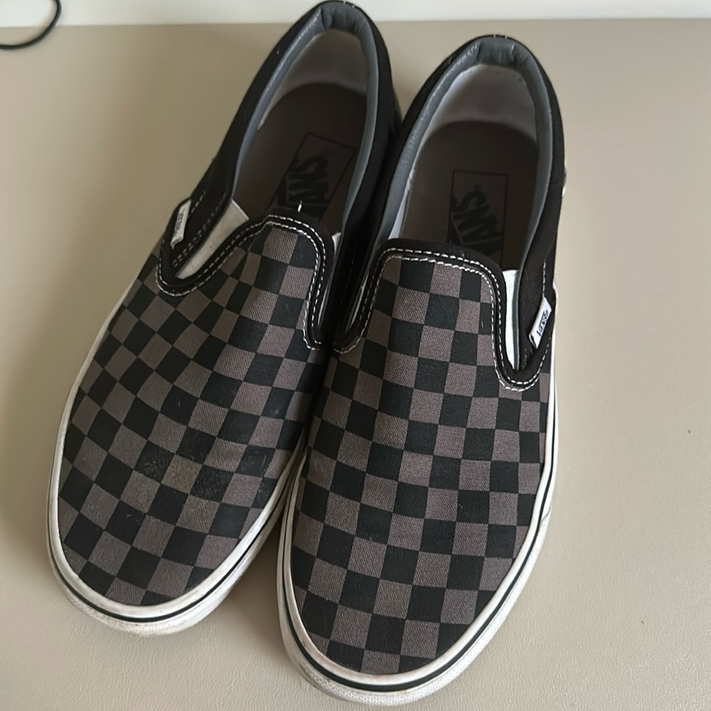 Used black and gray checkered slip on vans size: 7M/8.5W